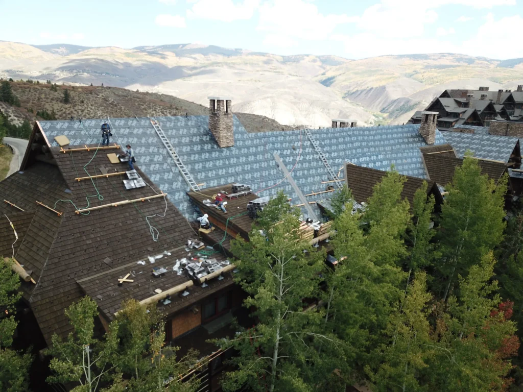 Crane-assisted CEDUR roofing installation at The Timbers.