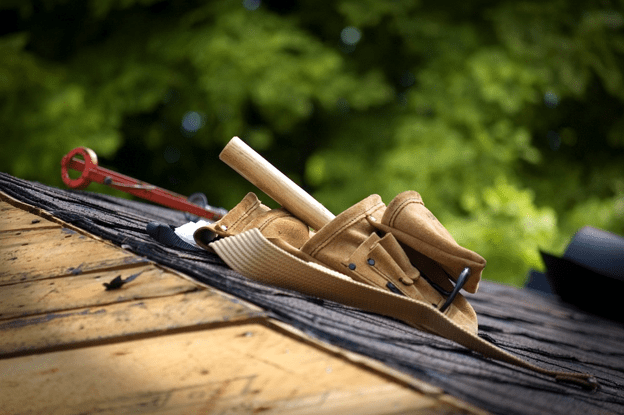 Roofing tools resting on a cedar shake roof during installation.