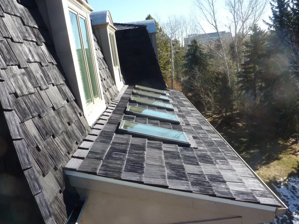 Synthetic wood shakes on a roof of a house. 