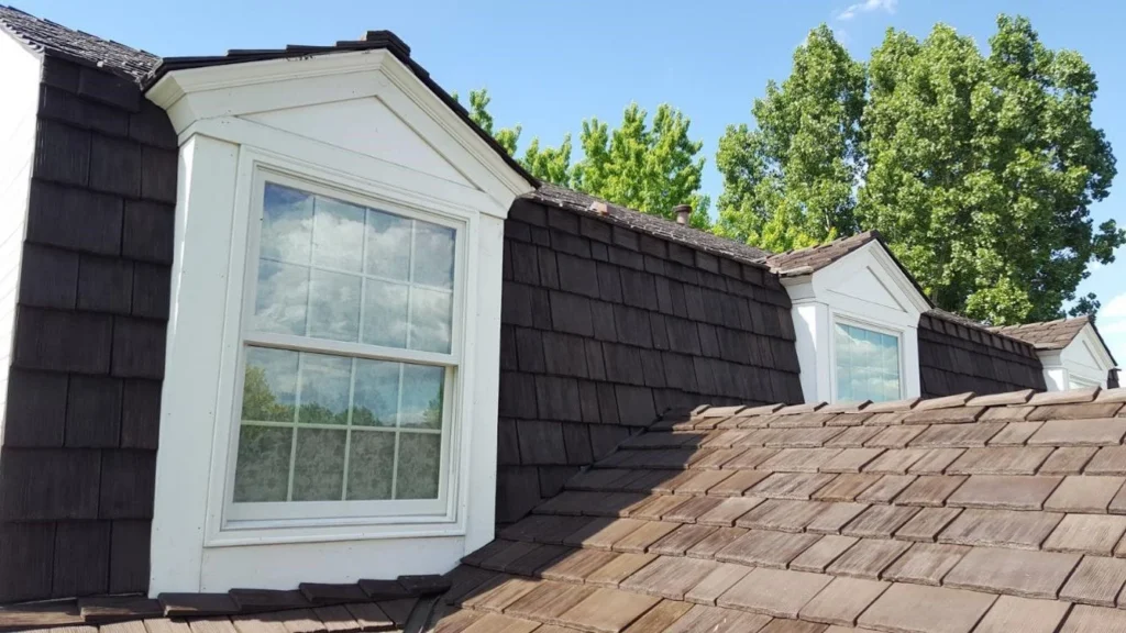 Cedar shake roof with dormer windows on a traditional home exterior.