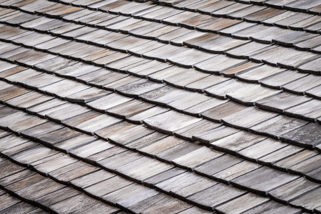 Warped wood shingles on a roof.