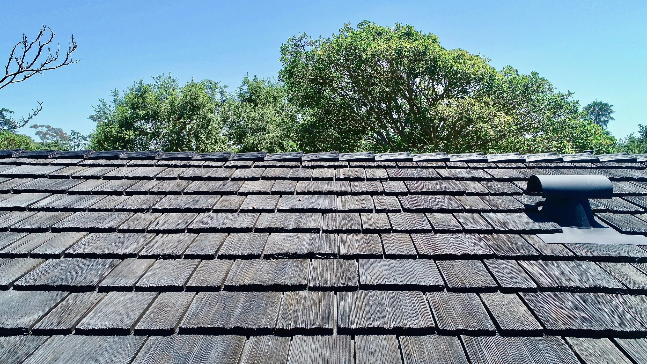 Darkly colored wood shake shingle fire resistant roof.