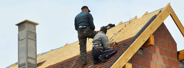 Roofing contractor in Colorado assessing hail damaged roof.