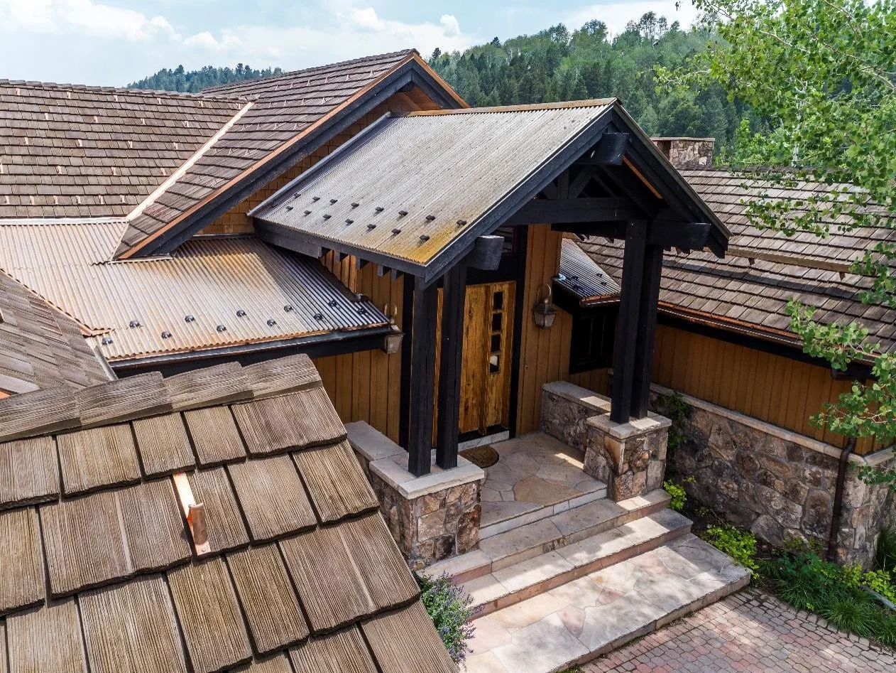 An image of a house with both metal and composite roofing.