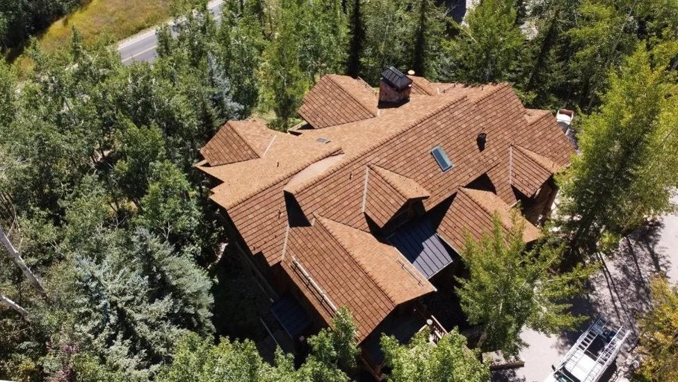 An image of a new CEDUR roof installed on a beautiful mountain home.