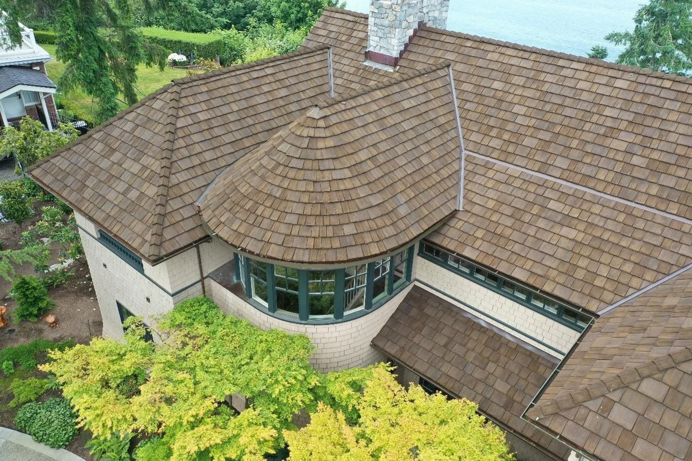 An image of a cedar shake roof on a two-story house.