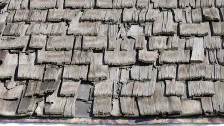 Wood roof that has hail damage and is missing cedar shakes.
