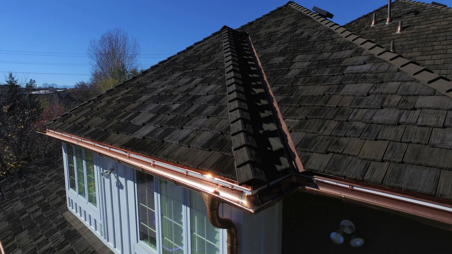 Synthetic faux wood shake roofing tiles.