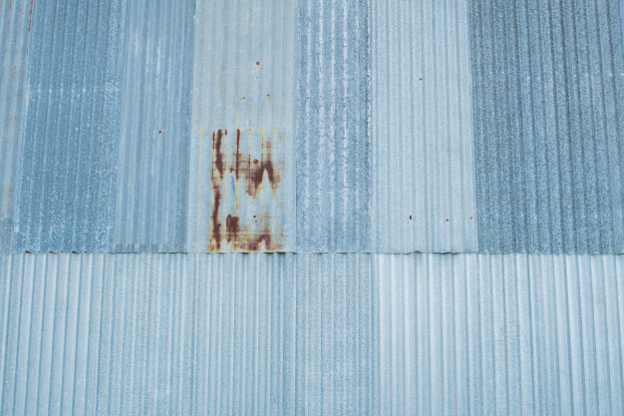 Metal roof shingles that are rusting.