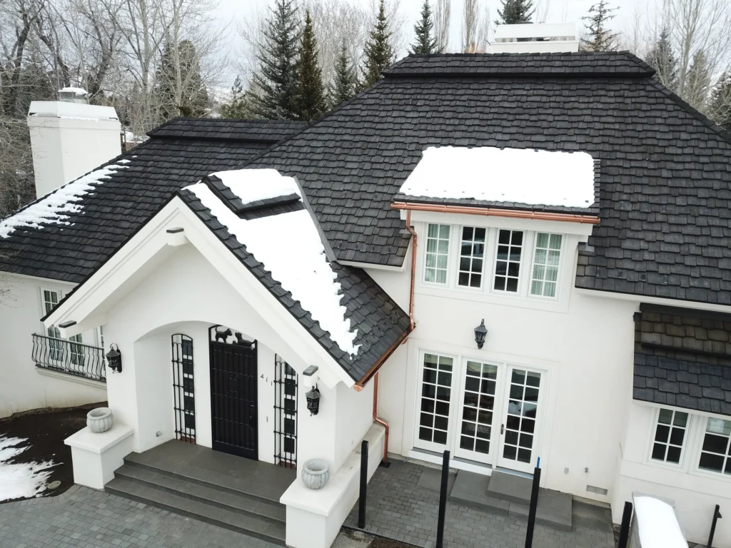 Home in the mountains with snow on the roof.