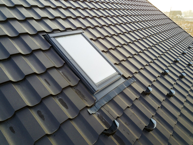 Metal roofing panels with skylight.