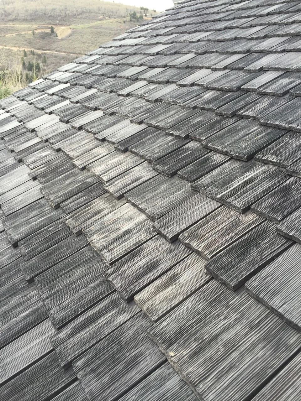 Synthetic composite cedar wood shake roofing tiles.