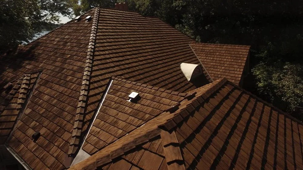 Cool roof with synthetic cedar shake roofing on a Tudor-style home.