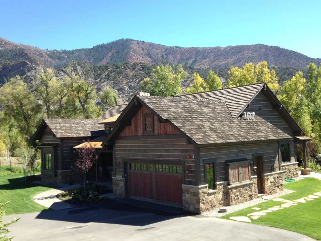 Rustic home exterior with multi-tone roof shingles.
