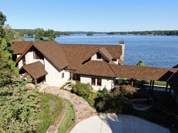 CEDUR Walden roof on a lakefront house with landscaped yard and water views.