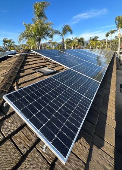 Solar panels installed on a CEDUR Walden roof at Marina Beach Motel in California, completed by Wicks Roofing.