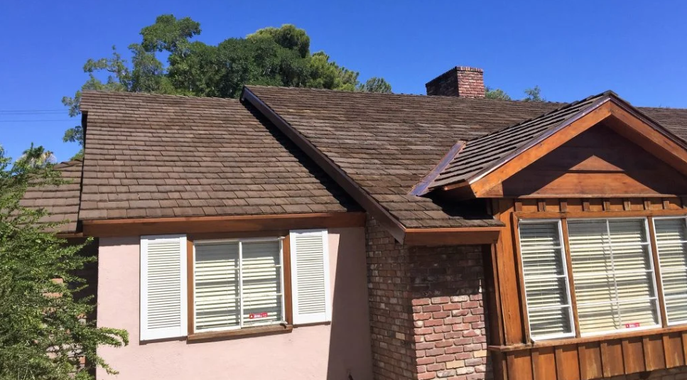 Home with brown CEDUR Shiloh shake roof and mixed brick and siding exterior.